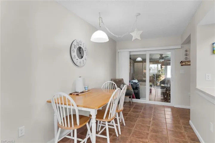 Dining area with tile patterned floors and a ceiling fan