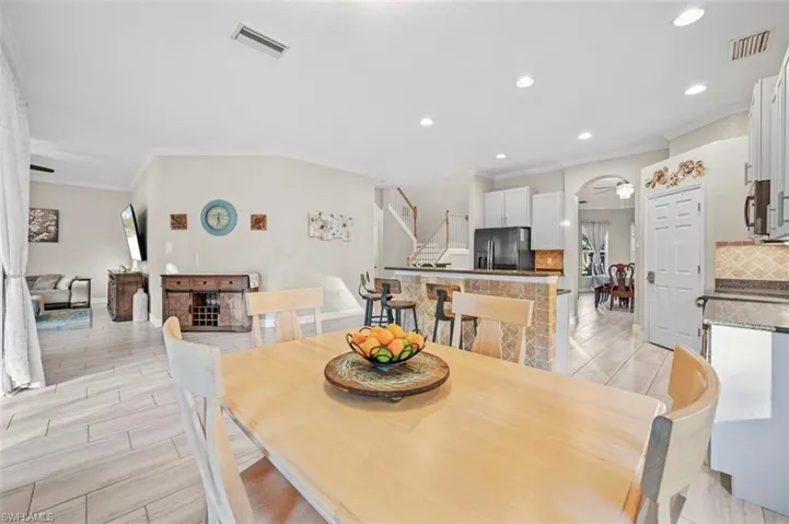Dining room featuring ceiling fan, light hardwood / wood-style floors, and ornamental molding