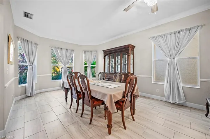 Dining room featuring ceiling fan and ornamental molding