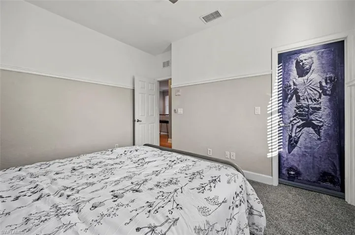 Carpeted bedroom with vaulted ceiling