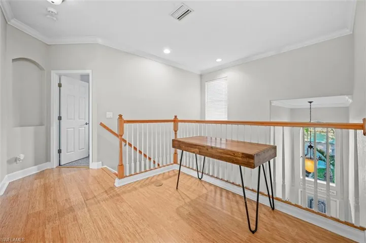 Corridor featuring light hardwood / wood-style floors and ornamental molding