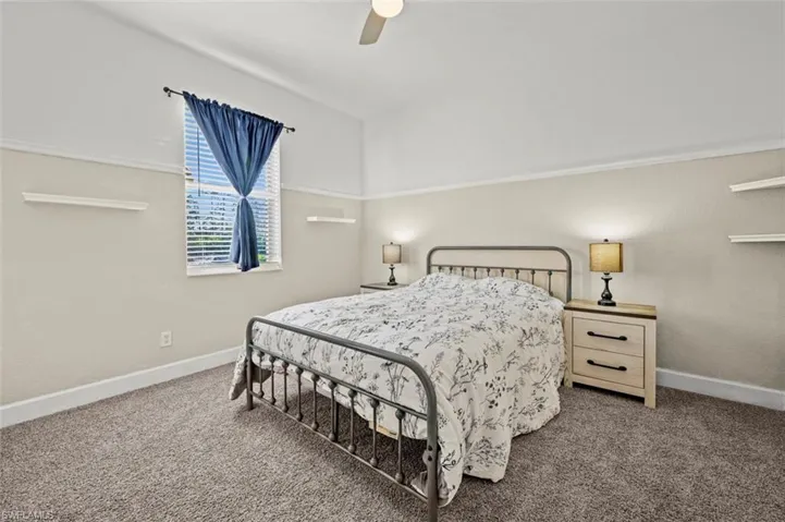 Bedroom with ceiling fan and carpet floors
