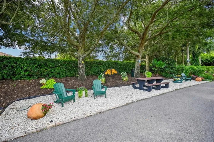 View of community featuring an outdoor fire pit and a patio area