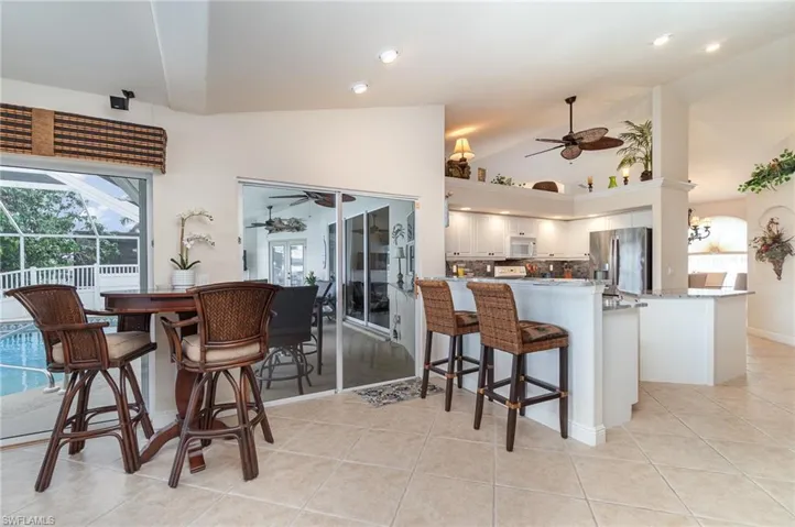 Dining room with recessed lighting, a ceiling fan, and light tile patterned flooring