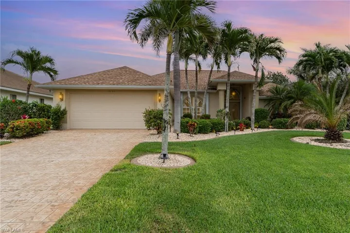 Ranch-style home with roof with shingles, stucco siding, decorative driveway, an attached garage, and a lawn