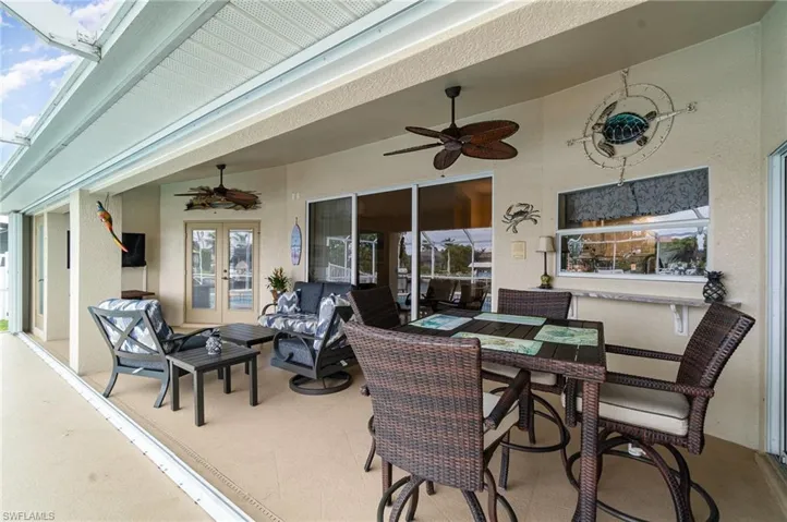 View of patio / terrace with outdoor dining space, french doors, and ceiling fan