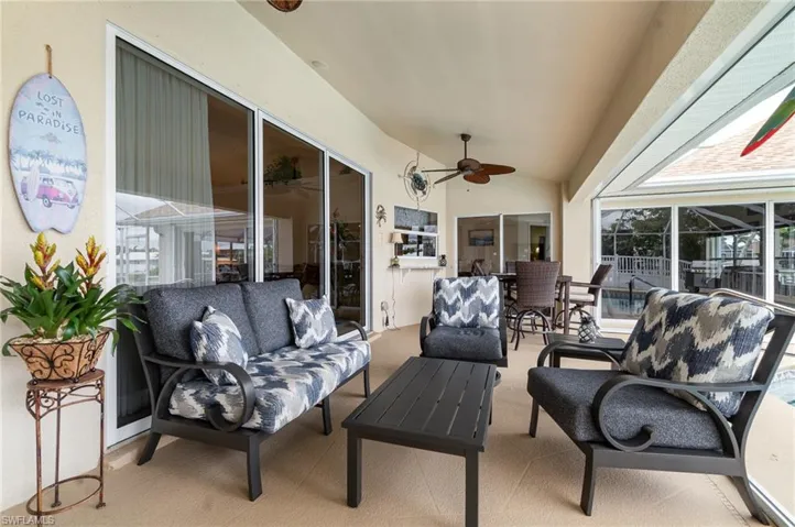 Sunroom featuring a ceiling fan and an outdoor hangout area