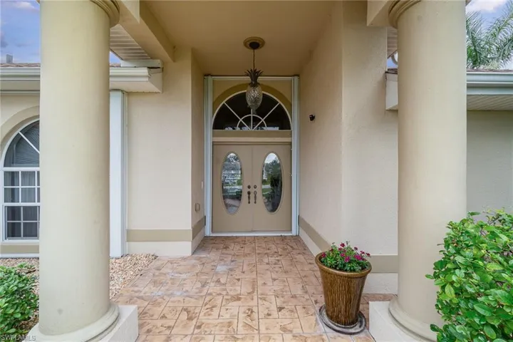 View of exterior entry with stucco siding