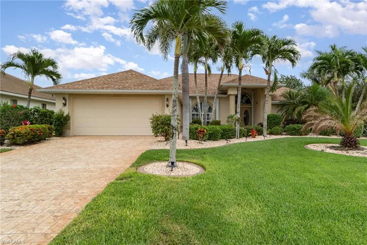 Single story home with a front yard, an attached garage, decorative driveway, and stucco siding