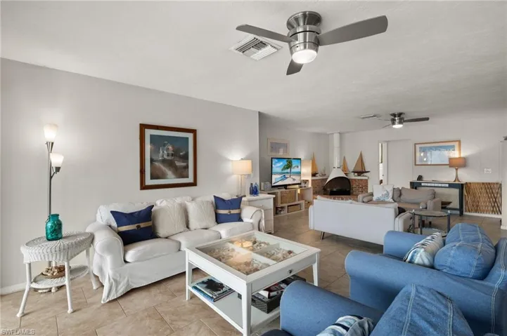 Tiled living room featuring baseboards