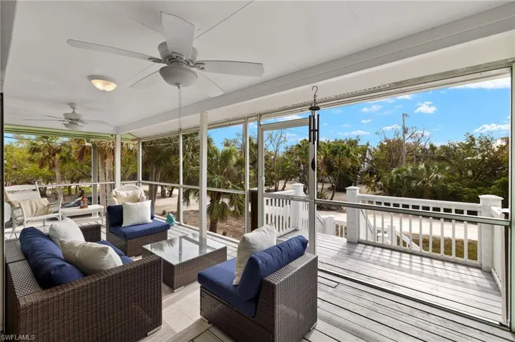 Sunroom / solarium with an outdoor living space, a ceiling fan, a deck, and healthy amount of natural light