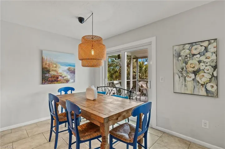 Dining space with baseboards and light tile patterned floors
