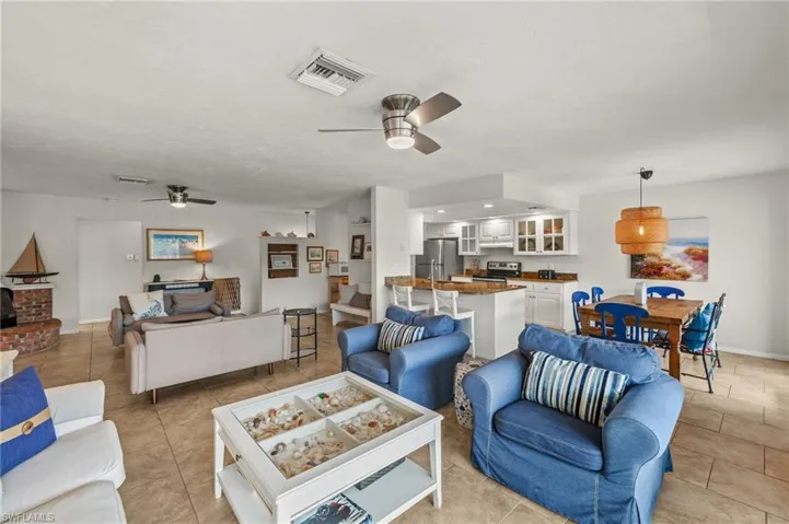 Living room with ceiling fan and light tile patterned floors