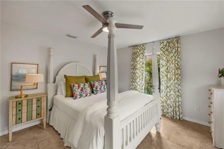 Bedroom with a ceiling fan and light tile patterned floors