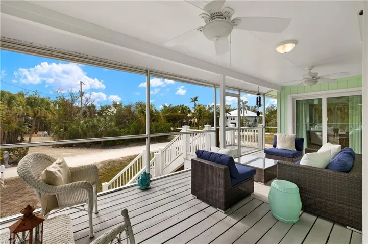Sunroom / solarium featuring an outdoor hangout area, ceiling fan, and a wooden deck