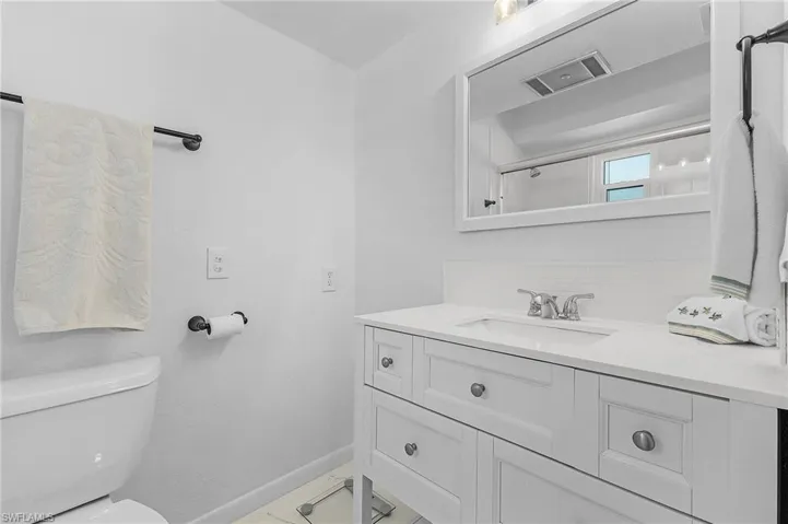 The primary bedroom has an en-suite bathroom with a raised vanity and a shower