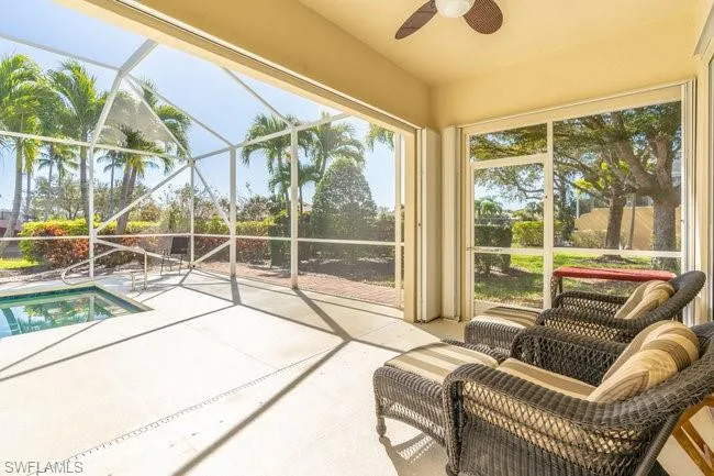 Sunroom / solarium featuring ceiling fan and a swimming pool