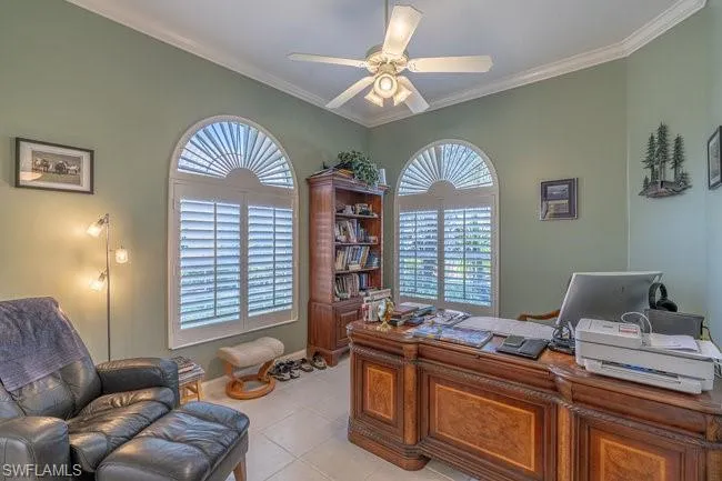 Office area with ceiling fan, crown molding, and light tile patterned flooring