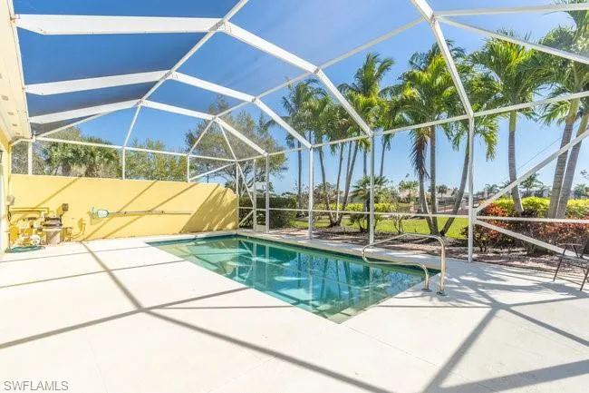 View of swimming pool with a lanai and a patio area
