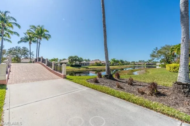 View of home's community with a lawn and a water view
