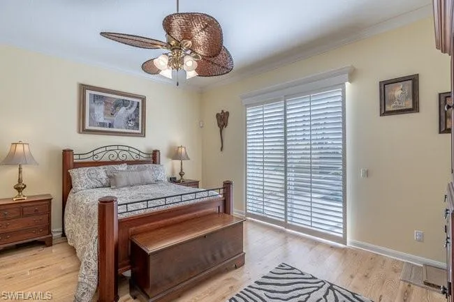 Bedroom featuring ceiling fan, light hardwood / wood-style flooring, and ornamental molding