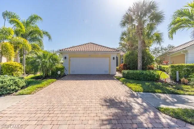 Mediterranean / spanish-style home with a garage