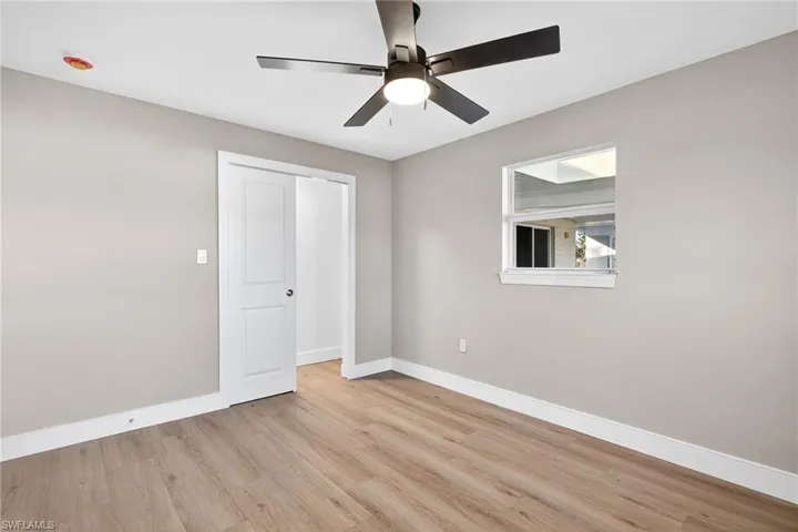 Unfurnished bedroom featuring light wood-style floors and a ceiling fan