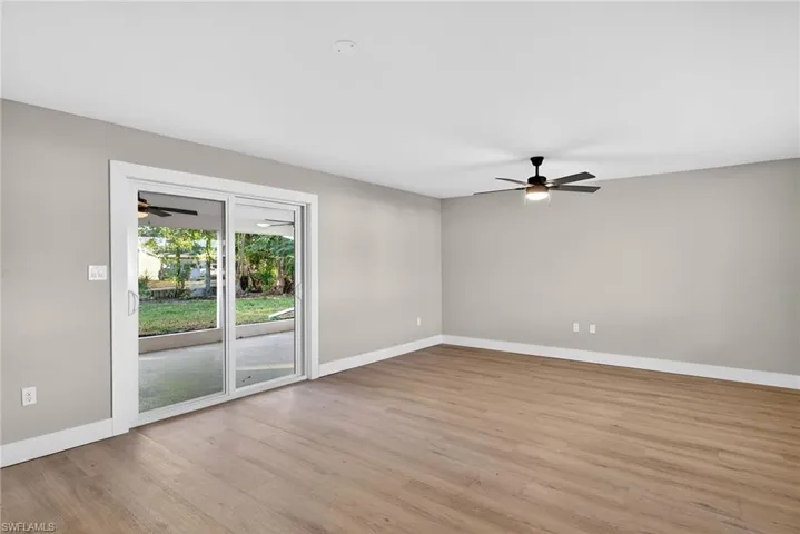Living room with a ceiling fan and light wood-style flooring