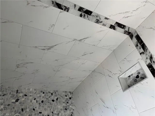 Master shower featuring glass enclosure and niche
