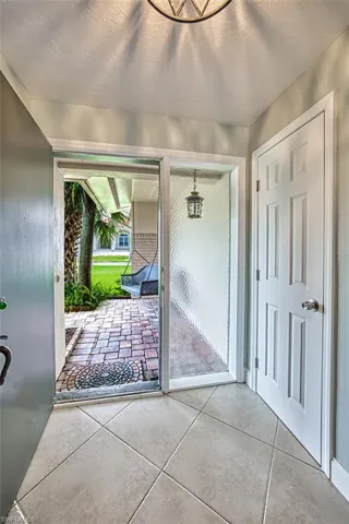 Doorway to outside featuring tile patterned flooring