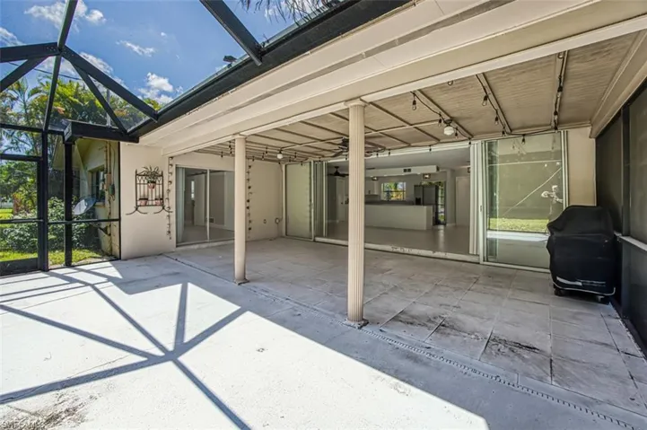 View of patio / terrace featuring a lanai