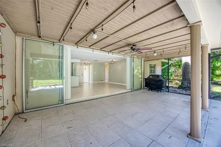 View of patio / terrace with ceiling fan and a grill