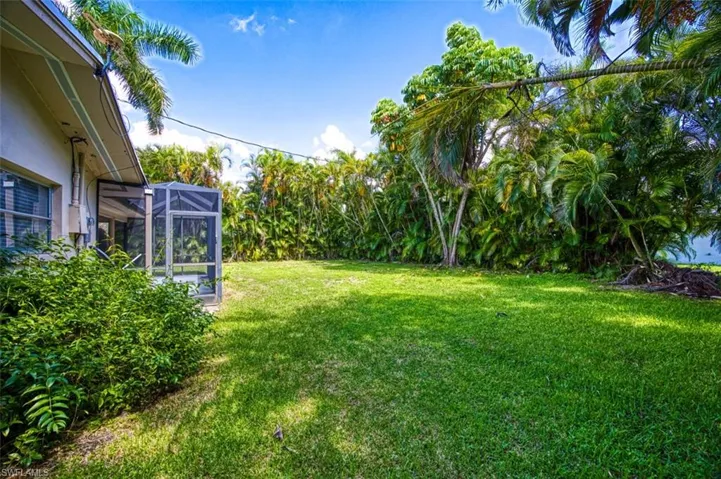 View of yard with glass enclosure