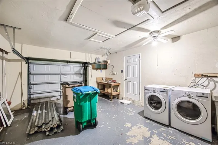 Washroom featuring attic access, washer and clothes dryer, and laundry area