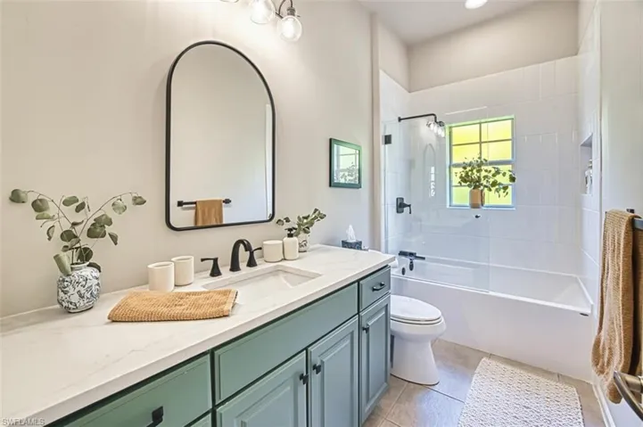 Full bathroom with toilet, tile patterned flooring, shower / bathing tub combination, and vanity