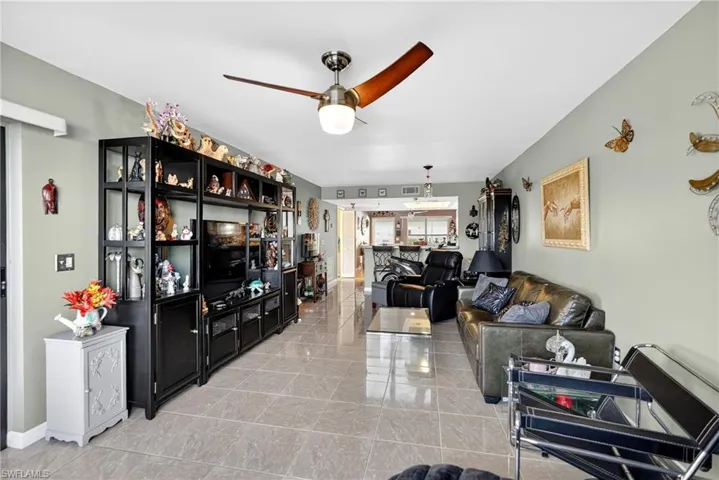Living room with a ceiling fan and baseboards