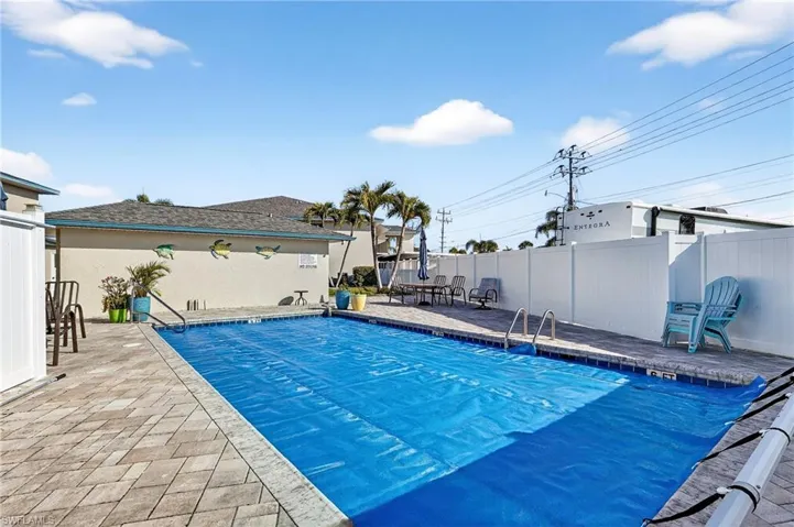 Community pool with a patio