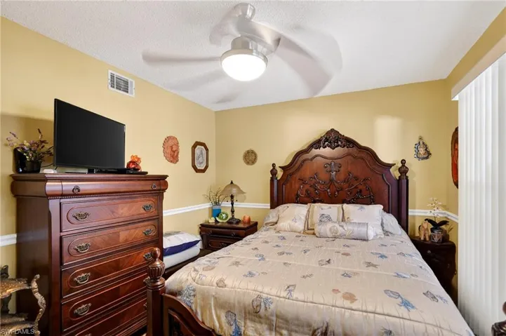 Bedroom featuring ceiling fan and a textured ceiling