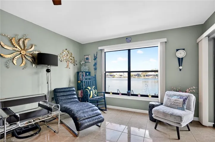 Living area with a water view and light tile patterned flooring