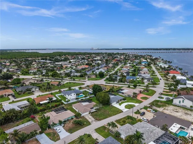 Aerial view of residential area featuring a large body of water