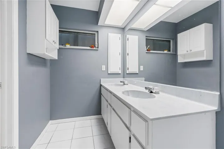 Bathroom featuring tile patterned floors and vanity