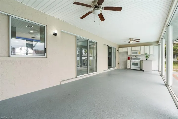 Unfurnished sunroom with ceiling fan