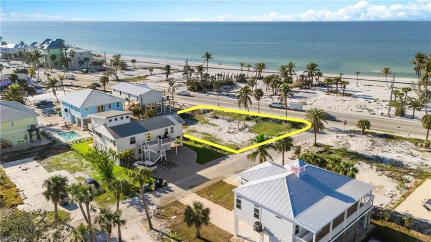 Aerial view with a water view and a view of the beach VIRTUALLY EDITED