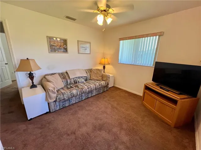 Guest bedroom featuring carpet and ceiling fan