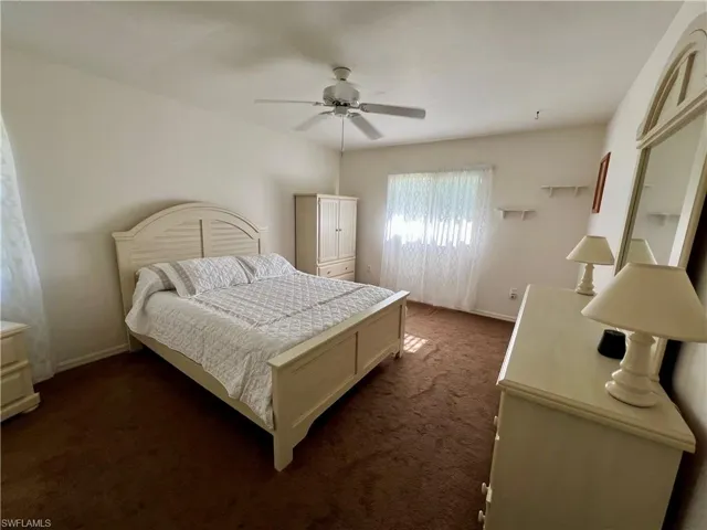 Carpeted bedroom with ceiling fan