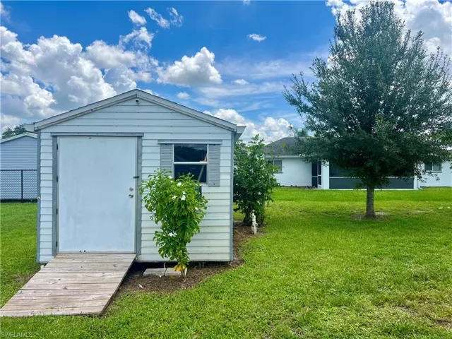 View of outbuilding with a yard