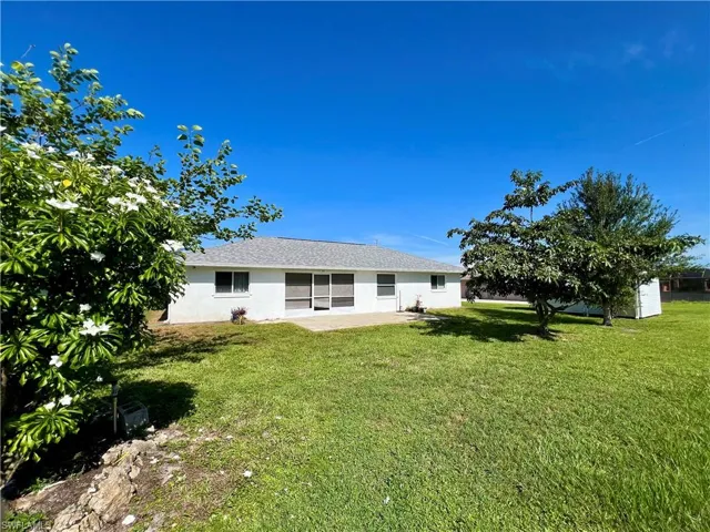Rear view of property featuring a lawn