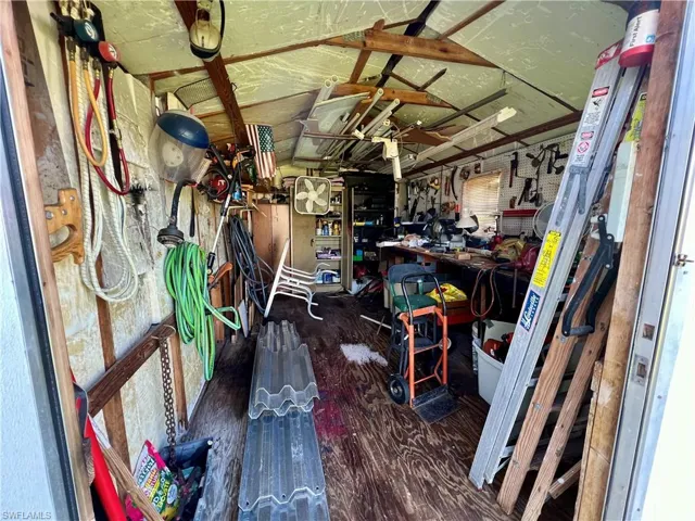 View of inside of storage shed with electric.