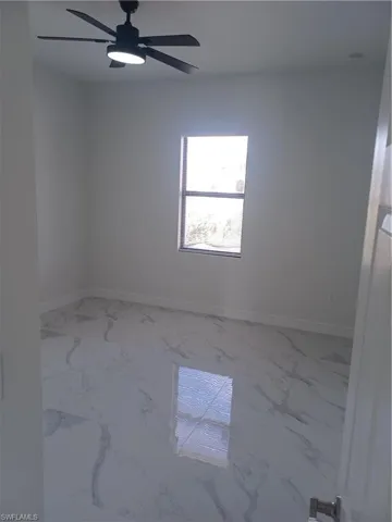 Empty room featuring ceiling fan