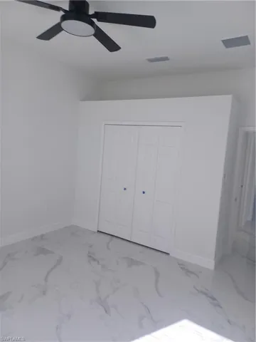 Unfurnished bedroom featuring a closet and ceiling fan